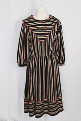 Women's vintage 1980's Walden Classics, Made in USA label 3/4 arm length midi length black striped dress with cinched waist, buttons on shoulders and triangle flap in front and back.