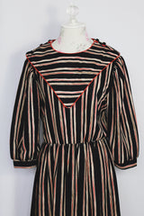 Women's vintage 1980's Walden Classics, Made in USA label 3/4 arm length midi length black striped dress with cinched waist, buttons on shoulders and triangle flap in front and back.