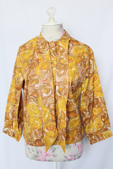 Women's vintage 1960's Diane Young label 3/4 arm length button up blouse in yellow and brown all over floral print
