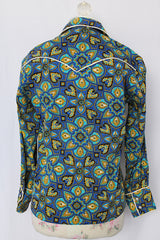 Women's vintage 1970's long sleeve button up western style blouse in all over blue print. White trim and pearl popper buttons.