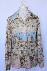 Women's vintage 1970's long sleeve button up blouse with pointy collar in thick polyester. Brown abstract print with pops of baby blue and pink.