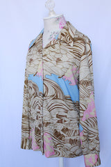 Women's vintage 1970's long sleeve button up blouse with pointy collar in thick polyester. Brown abstract print with pops of baby blue and pink.