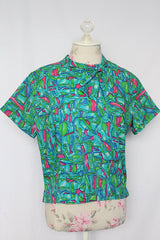Women's vintage 1960's Majorette short sleeve blouse with buttons in the back, attached tie bow on neck.
