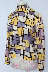 Women's vintage 1960's Fritzi of California label long sleeve mock neck blouse with zipper in the back.