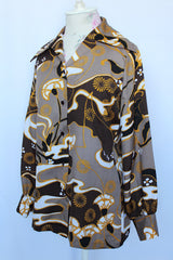 Women's vintage 1970's Le Soft Shirt by Lady Manhattan label long sleeve button up blouse with pointy dagger color and brown buttons in an all over brown, white, and mustard yellow print.