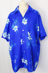 Women's or men's vintage 1970's Davina Honolulu label short sleeve button up shirt with pointy collar in all over blue Hawaiian floral print in lightweight polyester.