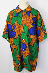 Women's or men's vintage 1970's Towncraft for JCPenney label short sleeve button up Hawaiian print shirt in brown, green, and blue Hawaiian print.