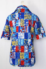 Women's vintage 1970's Hilton Head Islanders label short sleeve button up blouse with dagger collar in all over blue, white, and red floral print.