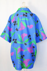 Women's or men's vintage 1990's Hilo Hattie, Made in Hawaii short sleeve button up shirt in all over blue Hawaiian floral print.