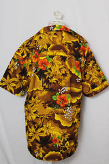 Women's or men's vintage 1970's short sleeve button up Hawaiian print shirt in yellow and brown colors.