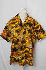 Women's or men's vintage 1970's short sleeve button up Hawaiian print shirt in yellow and brown colors.