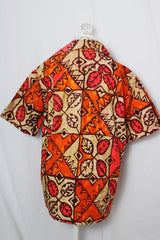 Women's or men's vintage 1960's made in Hawaii short sleeve button up shirt with pointy collar in cotton material with all over tan, orange, and pink Hawaiian print.