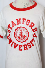 Women's or men's vintage 1970' Champion label short sleeve white tee with red trim around cuffs and neck. Stanford University graphic on the front.