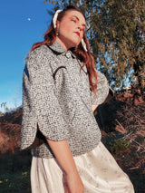 Women's vintage 1940's Bedell, An Original by Solmar - The Finest Name in Fashion label short sleeve wool cropped jacket with one button closure. Has small rounded collar, big clear button, blue colored.