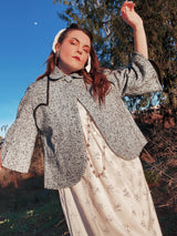 Women's vintage 1940's Bedell, An Original by Solmar - The Finest Name in Fashion label short sleeve wool cropped jacket with one button closure. Has small rounded collar, big clear button, blue colored.