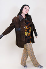 Women's or men's vintage 1970's Montgomery Ward label long sleeve brown suede jacket with popper buttons and dark brown leather trim.