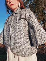 Women's vintage 1940's Bedell, An Original by Solmar - The Finest Name in Fashion label short sleeve wool cropped jacket with one button closure. Has small rounded collar, big clear button, blue colored.