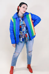 Women's or men's vintage 1970's Montgomery Ward Custom Outerwear label long sleeve ski jacket in blue with yellow, red, and green stripes in the front.