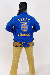 Women's or men's vintage 1960's (67'-68') Fab-Knit Quality Supreme label long sleeve navy blue corduroy zip up FFA jacket with patches and text embroidery throughout.