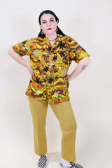 Women's or men's vintage 1970's short sleeve button up Hawaiian print shirt in yellow and brown colors.
