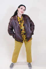 Women's vintage 1970's Adler Leather MFG. CO., Made in California label short length long sleeve brown leather button up jacket with double lapel.