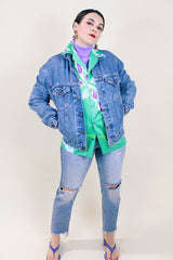 Women's or men's vintage 1990's medium wash blue button up Levi's denim jacket with collar.