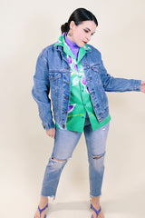 Women's or men's vintage 1990's medium wash blue button up Levi's denim jacket with collar.