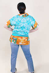 Women's vintage 1980's Beldoch Popper, Made in USA label sleeveless turquoise blue sweater vest with all over silvery white print.