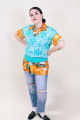 Women's vintage 1980's Beldoch Popper, Made in USA label sleeveless turquoise blue sweater vest with all over silvery white print.