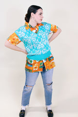 Women's vintage 1980's Beldoch Popper, Made in USA label sleeveless turquoise blue sweater vest with all over silvery white print.