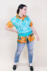 Women's vintage 1980's Beldoch Popper, Made in USA label sleeveless turquoise blue sweater vest with all over silvery white print.