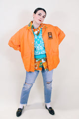 Men's or women's vintage 1970's Pla-Jac by Dunbrooke label long sleeve orange lightweight windbreaker with two patches on left chest.