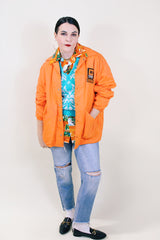 Men's or women's vintage 1970's Pla-Jac by Dunbrooke label long sleeve orange lightweight windbreaker with two patches on left chest.