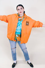 Men's or women's vintage 1970's Pla-Jac by Dunbrooke label long sleeve orange lightweight windbreaker with two patches on left chest.