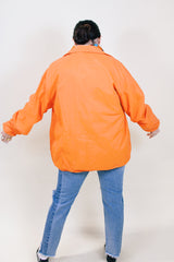 Men's or women's vintage 1970's Pla-Jac by Dunbrooke label long sleeve orange lightweight windbreaker with two patches on left chest.