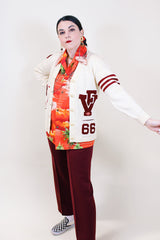Women's vintage 1960's Kandel All National label long sleeve button up wool cream colored cardigan with two front pockets and various maroon colored patches.