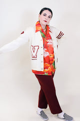 Women's vintage 1960's Kandel All National label long sleeve button up wool cream colored cardigan with two front pockets and various maroon colored patches.