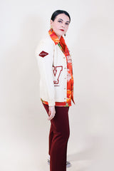 Women's vintage 1960's Kandel All National label long sleeve button up wool cream colored cardigan with two front pockets and various maroon colored patches.