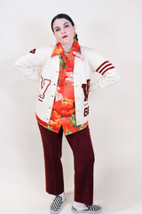 Women's vintage 1960's Kandel All National label long sleeve button up wool cream colored cardigan with two front pockets and various maroon colored patches.