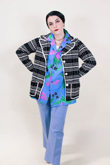 Women's vintage 1960's Lilly of California label long sleeve button up black and white striped cardigan with two front pockets, a double lapel, and white square buttons.