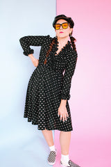 long sleeve knee length black dress with polka dots ruffle neckline and cuffs vintage 1970's