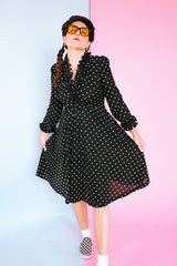 long sleeve knee length black dress with polka dots ruffle neckline and cuffs vintage 1970's