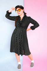 long sleeve knee length black dress with polka dots ruffle neckline and cuffs vintage 1970's