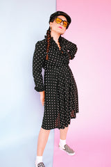 long sleeve knee length black dress with polka dots ruffle neckline and cuffs vintage 1970's