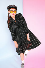 long sleeve knee length black dress with polka dots ruffle neckline and cuffs vintage 1970's