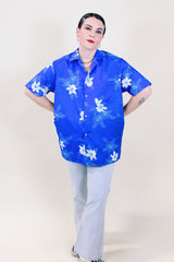 Women's or men's vintage 1970's Davina Honolulu label short sleeve button up shirt with pointy collar in all over blue Hawaiian floral print in lightweight polyester.