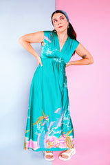 sleeveless maxi length turquoise dress with floral and bird print around hem vintage 1970's