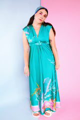 sleeveless maxi length turquoise dress with floral and bird print around hem vintage 1970's