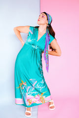 sleeveless maxi length turquoise dress with floral and bird print around hem vintage 1970's