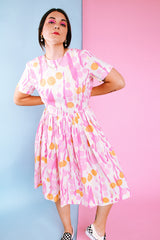 short sleeve midi length 1960's dress in white with pink and orange print
